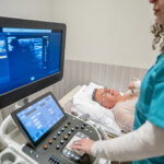 women doing echo test on a patient