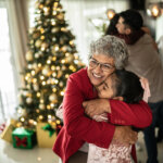 elderly woman hugging granddaughter wanting to learn about heart health during the holiday season