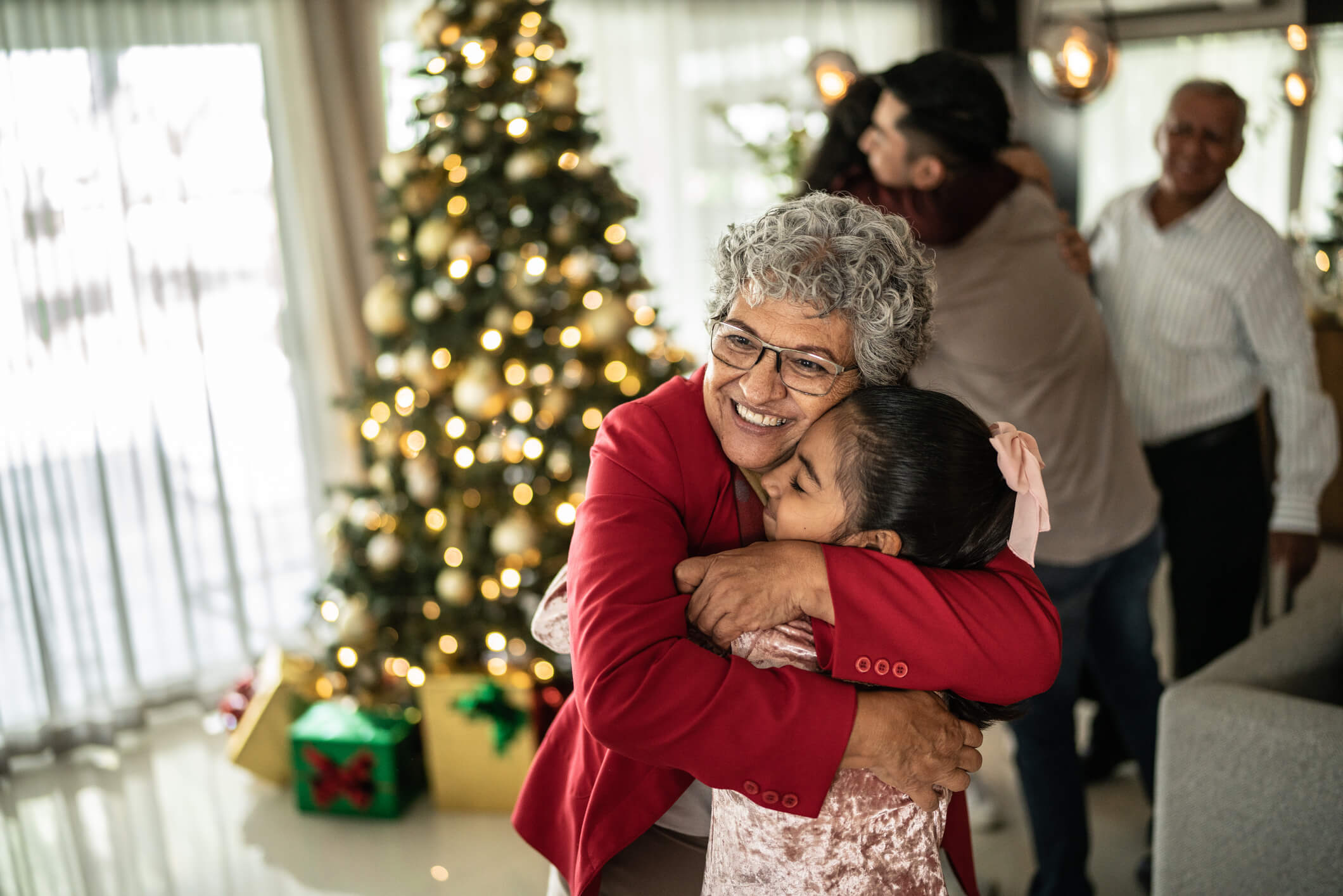 elderly woman hugging granddaughter wanting to learn about heart health during the holiday season